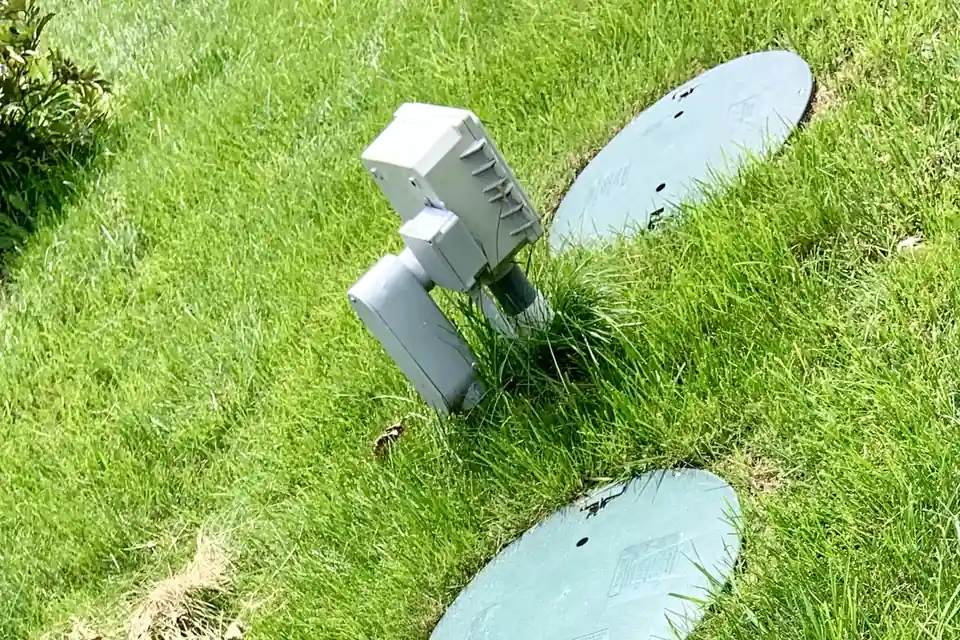 Septic access lids in a lawn, typical of residential septic systems in Buncombe County and Asheville NC mountain homes.